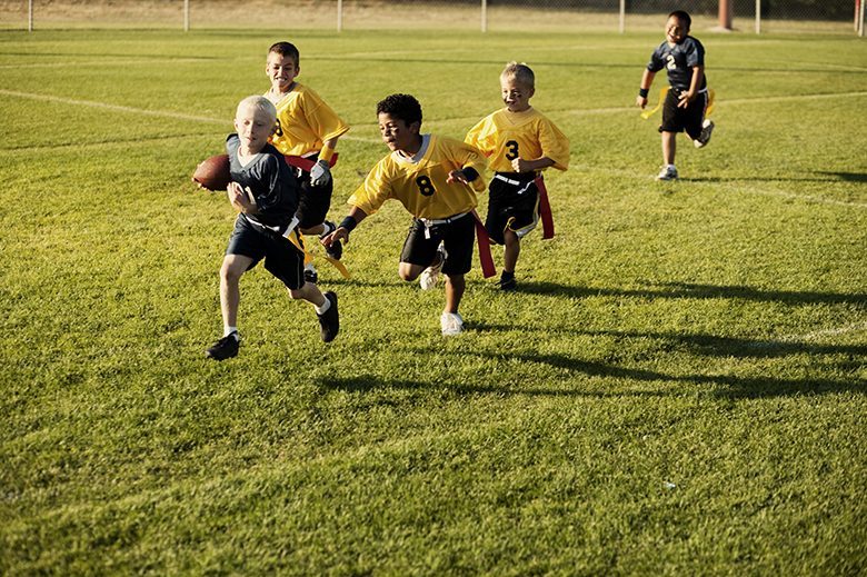 Flag Football Action A young boy goes for the flag football touchdown.